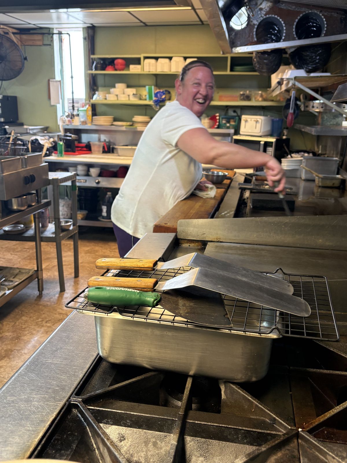 A cook grinning at the griddle line