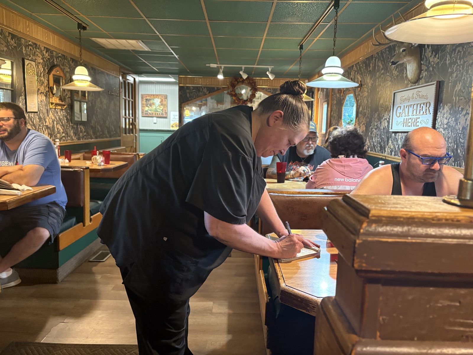 A server writing down an order in the dining room