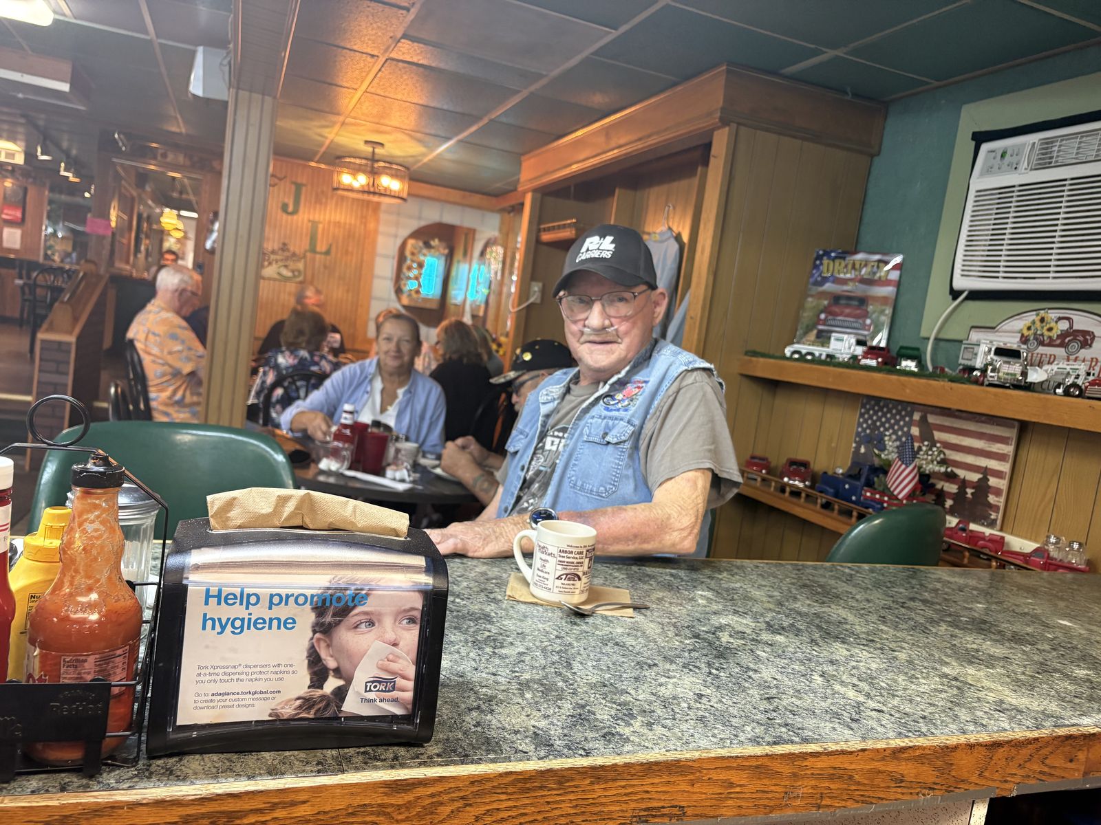 A regular enjoying coffee at the counter