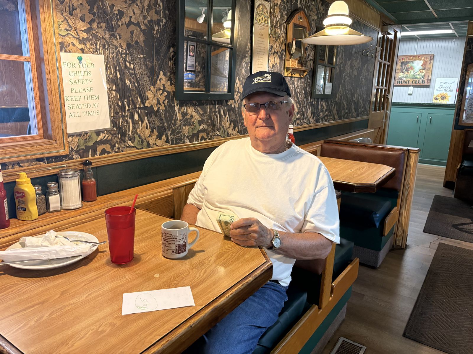 A regular with his morning coffee in a booth