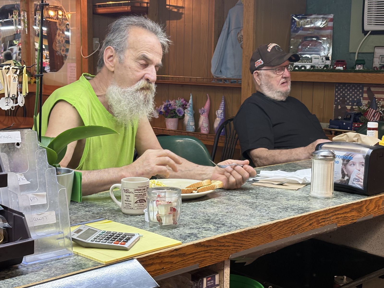 Two regulars visiting over breakfast at the counter